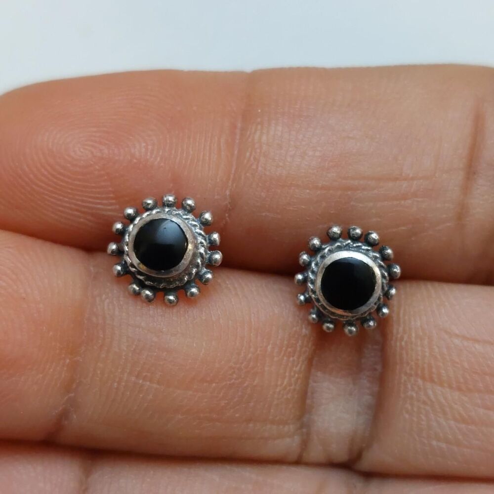 Solid sterling silver stud earrings dotted with a bright polished black onyx sto